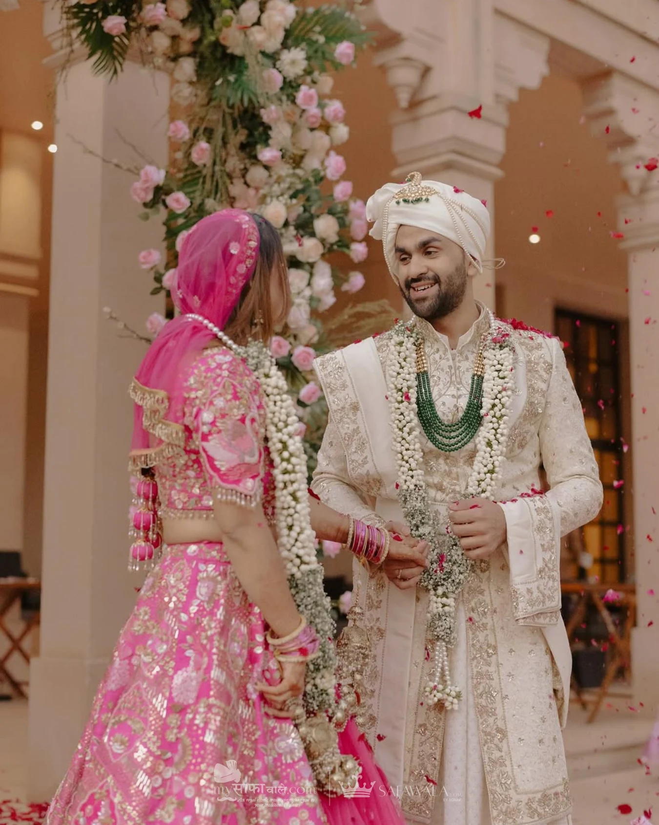 Close detail of a red wedding safa with an emerald kalgi for Family Pagdi Styling